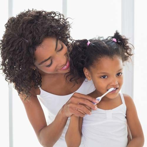 Mother Brushing Childs Teeth